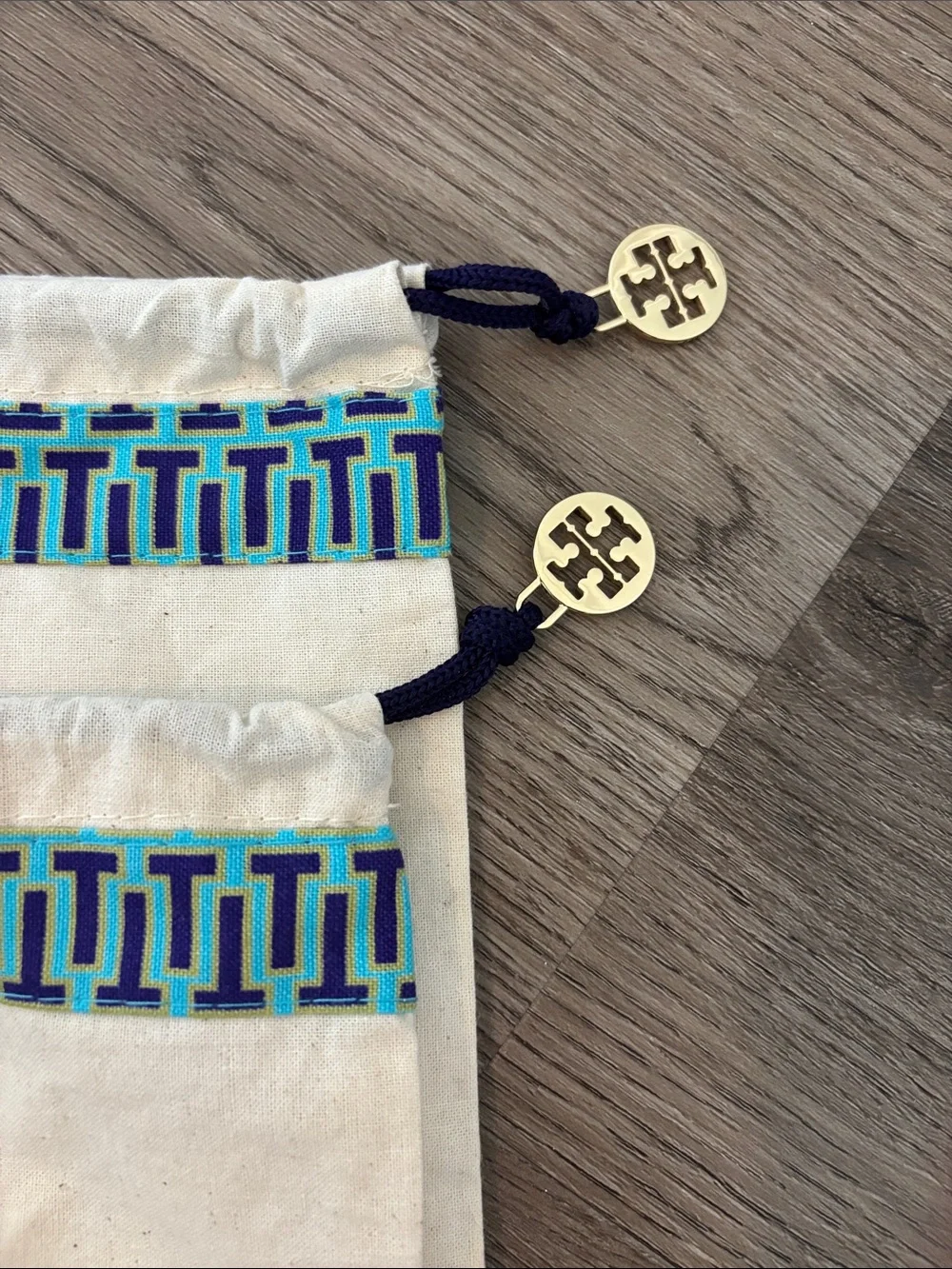 Set of 2 Tory Burch drawstring dust bags, canvas with gold charm